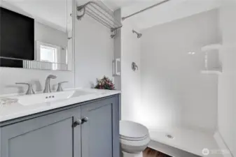 This lovely bathroom & the 2nd bedroom are at the one end of the home & the primary bedroom & bathroom are at the other end. Nice floor plan!