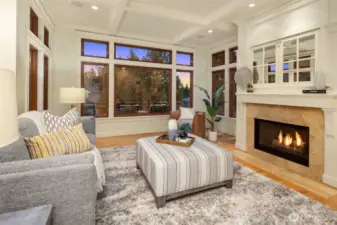Box beam ceilings, a substantial fireplace and elevated ceilings make this family room a favorite place to gather.