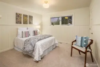 Custom painted  beadboard in all of its glory gives this bedroom character galore.