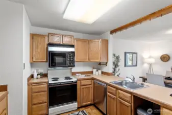 The kitchen opens up to the dining area, lots of light, counter space and extra space for more than one cook!