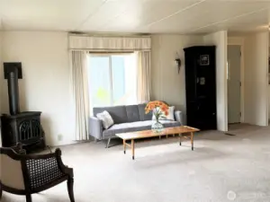 Bright living area with cozy gas fireplace.