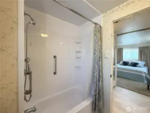 Looking from primary bathroom to bedroom