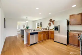 Kitchen looking toward the front of the house. Space for a hutch in the dining space. Line up the barstools for casual eating.