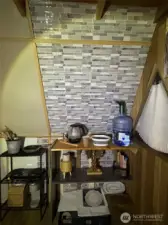 kitchenette station with drinking water set up, rechargeable faucet that has a long term charge, electric cook top, kettle, portable sink, and more!