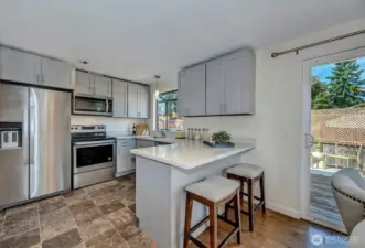 Updated kitchen with quartz counters and stainless steel appliances