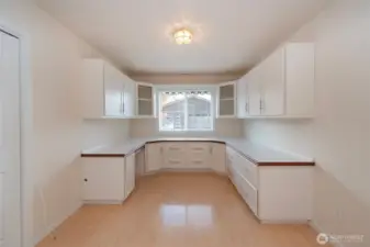 Office with custom cabinets and drawers.