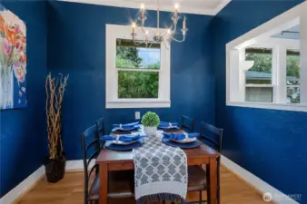 Very cute dining nook off of kitchen has cut out to the living space.