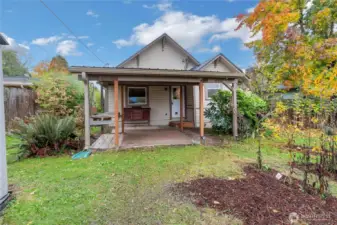Backyard has large covered space, tons of fruit trees and lounging space!