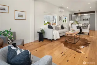 This large great room runs the length of the house with vaulted ceilings, wood flooring and designer cabinets.