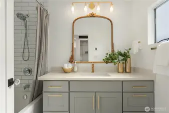 This lovely bath features heated tile floors and a tiled bath surround as well as great storage in the oversized vanity.