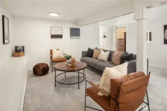 Looking across the rec room shows off the size a bit more. A high outlet for a wall mount tv is under the picture on the left.