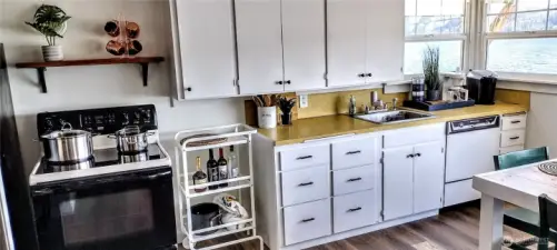 Open kitchen and dining area with large picture windows to bathe you in sunlit morning light.
