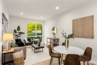 Make yourself at home in this bright and inviting living area, where natural light and greenery outside create a peaceful, relaxing vibe. Perfect for unwinding after a busy day.