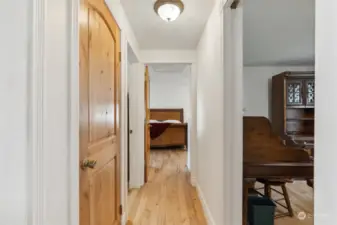 Hallway to more joy!!  Office on right, closet and 2nd full bathroom on the left, primary bedroom down the hall.