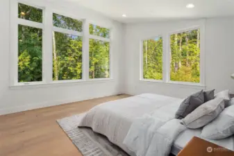 Primary bed features upgraded hardwood flors and dramatic vaulted ceiling with greenbelt views