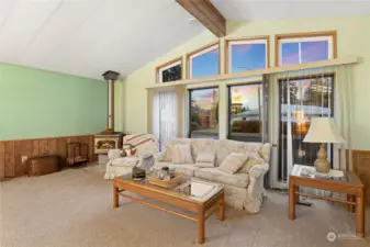 You'll love the soaring vaulted ceilings, and amazing large windows bring in loads of light. There is a wood burning stove for cozy comfort during those chilly winter days and nights, and an expansive deck plus hot tub for other times.