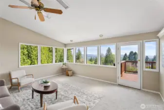 Main Level - Living Room filled with natural light from abundant windows, framing views of the countryside, Rainier Bridge, Columbia River, and breathtaking sunsets.
