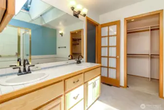 Primary bath with double vanities and spacious walk-in closet.