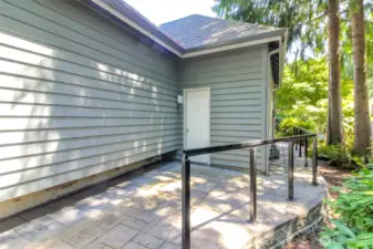 Door leading out of the garage with pathway leading from front to back of the home.