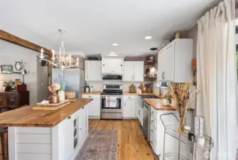 Beamed ceilings, plenty of characteristic cabinets, stainless steel appliances, and full tile backsplash