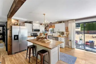 Bright and open kitchen - leads out to a large, level lot with multiple entertaining/relaxing areas.  Fully fenced too!