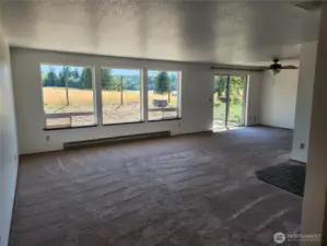 New paint inside the home brighten the spacious living area with wonderful windows allowing light and territorial views.  Sliding door to the right of photo.