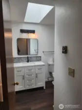 Beautifully updated guest bath with nice sized vanity for storage. Another skylight allowing so much light in the bathroom.