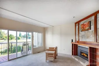 Check out the incredible detail of this main floor living room.  A wall of windows allows loads of  natural light.  Custom cherry and stone natural gas fireplace and mantle is a unique statement piece.  Brand new carpet installed throughout.