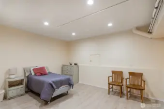 Located on the lower level, this large bonus area is  currently being used as a bedroom.