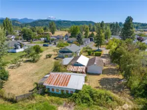 Four out buildings A barn 2garages and a green house all on shy acre. All with Mountain view.