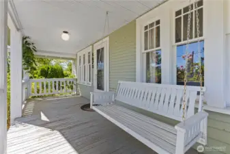 Covered front porch wirh bench swing looking at the mountain