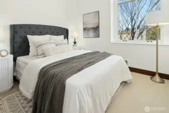 Large window in Bedroom with window coverings