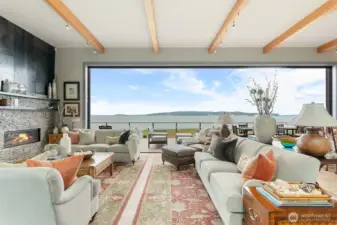 From the moment you enter, a dramatic 28-foot disappearing glass wall opens the Great Room directly to the water — seamlessly blending interior living with the horizon beyond.