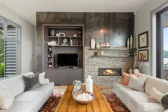 A custom cold-rolled steel accent wall anchors the living space, introducing rich texture and modern architectural depth.