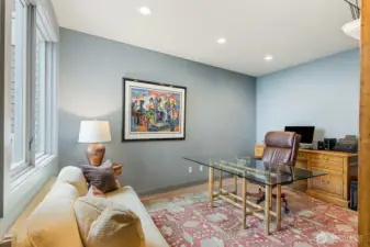 Executive office with water views, positioned on the main level and adjacent to a full bath with shower, thoughtfully designed with potential to convert into a private ADU-style suite.