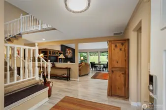 The spacious entry opens into the great room, with recently updated LVP flooring flowing across the entire main level of the home.  1/2 bath and kitchen access on the right of the entry.