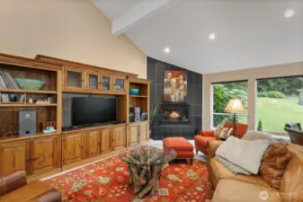 This great room is spacious enough for a crowd, but cozy enough to settle in on a chilly evening. Vaulted ceilings and stylish wood-burning fireplace give it a bit of drama.