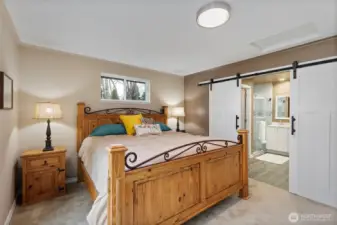 Through the charming barn doors, enter into the spacious 3/4 bath!