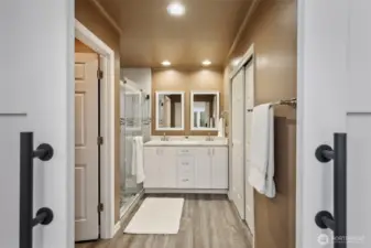 This 3/4 bath has it all...spacious tiled shower, double vanities with quartz counter, and a huge closet to the right.