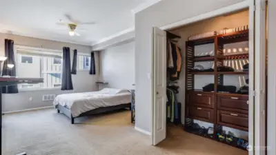 Generous sized walk-in closet with convenient organizer and bi-fold doors.