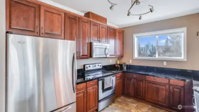 Warm toned cabinets, welcoming vibes, this kitchen is the heart of the home, ready for your personal touch.