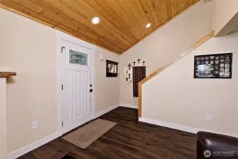 Main entry and stairway to loft bedroom with view and half bath.
