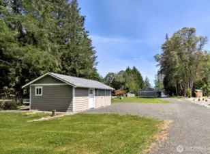 Private well and well house with additional double doors to roomy storage space.
