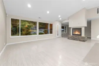 Great room with gas fireplace and luxury Vinyl  Plank flooring. Large windows for great natural lighting.