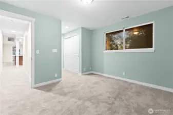 Primary bedroom with 3/4 bath and new carpet.