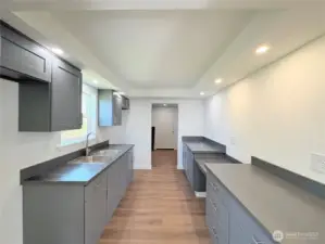 Kitchen with plenty of counter tops and cabinets for storage.