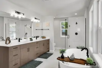 The spa-inspired primary bath boasts a large tiled shower, a deep soaking tub, and a dual vanity with tons of storage.