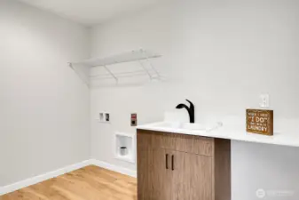 Spacious laundry with utility sink on the upper level.