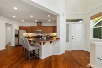 Kitchen centered between main entrance and garage entrance