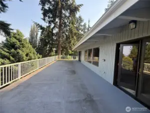 deck attached to kitchen, primary bedroom, and living room